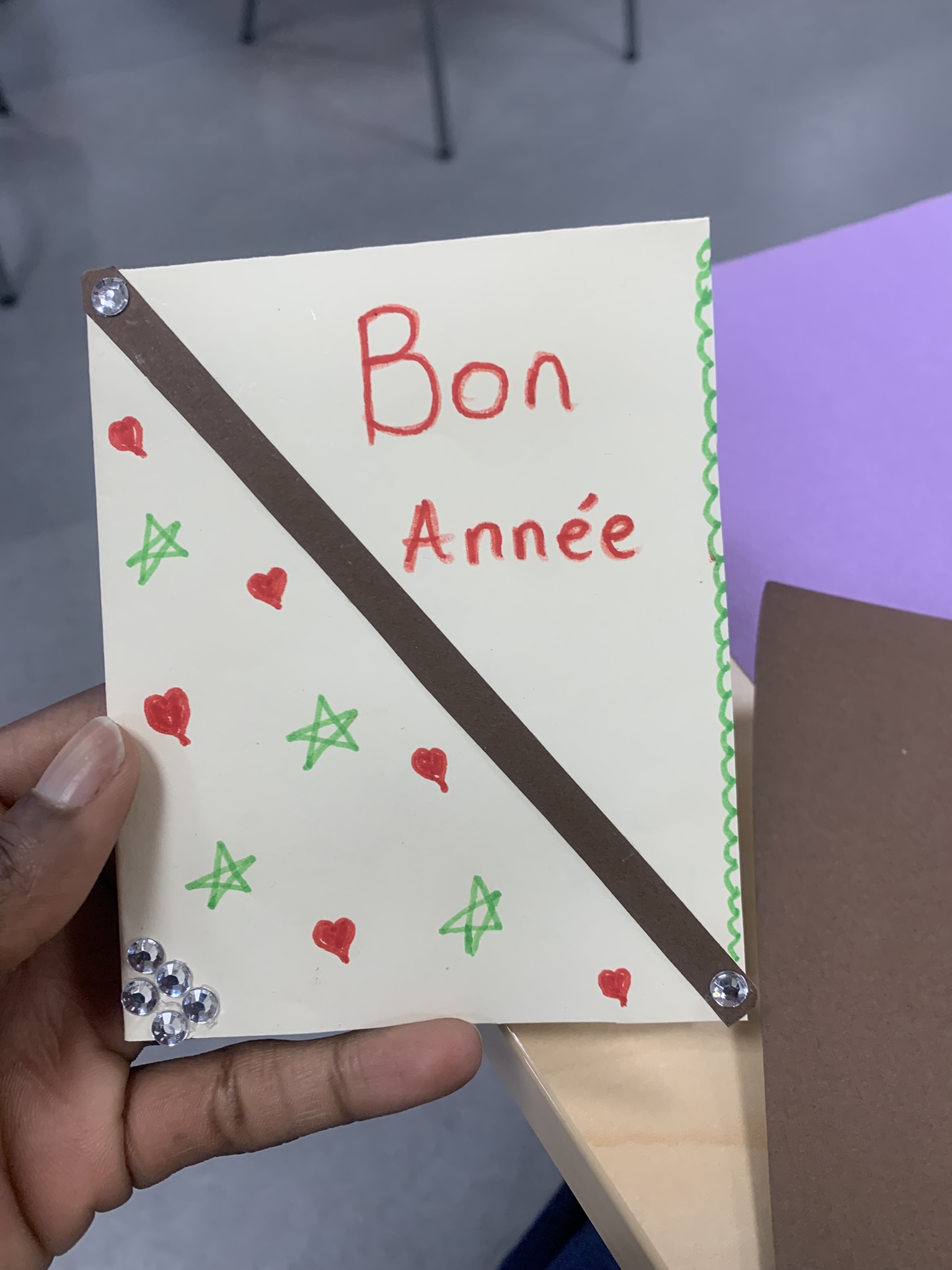Volunteer's hands organizing colorful cards on a wooden table
